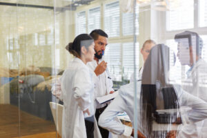 scientists and researchers look at a screen